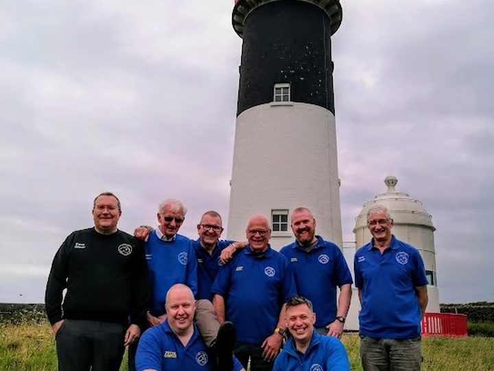 The club team gathered at the lighthouse.
