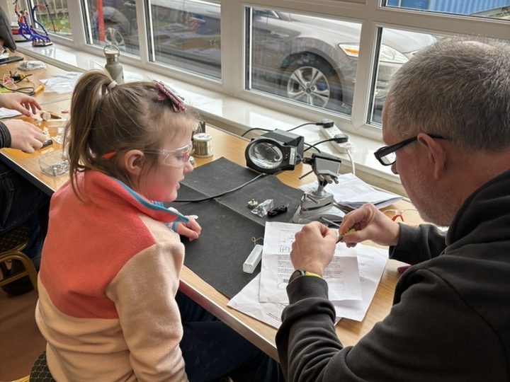 One-to-one guidance during the electronics workshop.