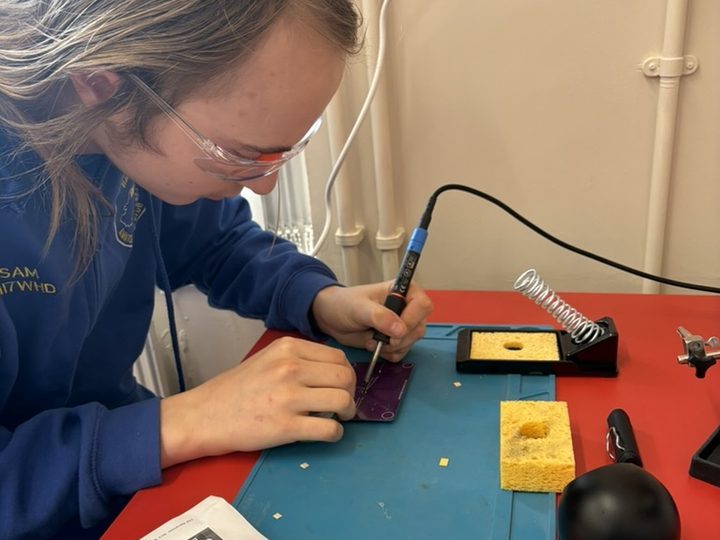 Careful soldering work on a circuit board.