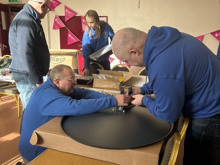Assembling portable satellite equipment.